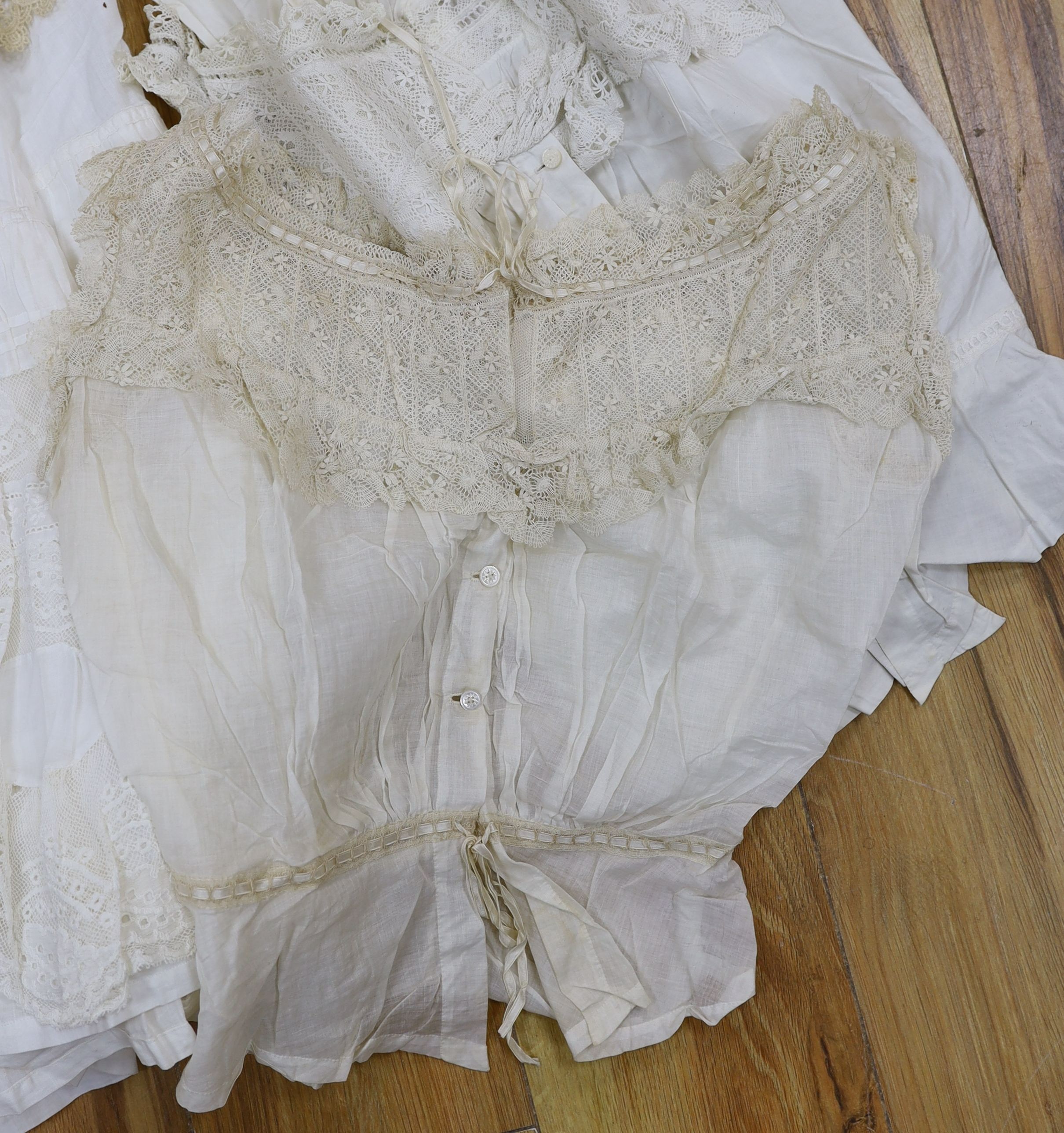 Five Victorian and Edwardian lace inserted camisole tops, a cream chemical lace jacket and a whitework and lace petticoat